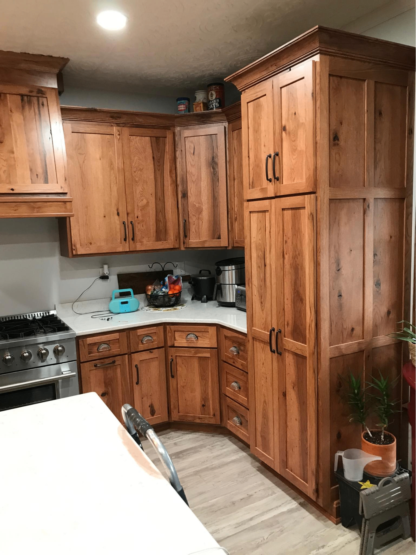 Custom pantry wall and corner cabinetry in warm stained wood